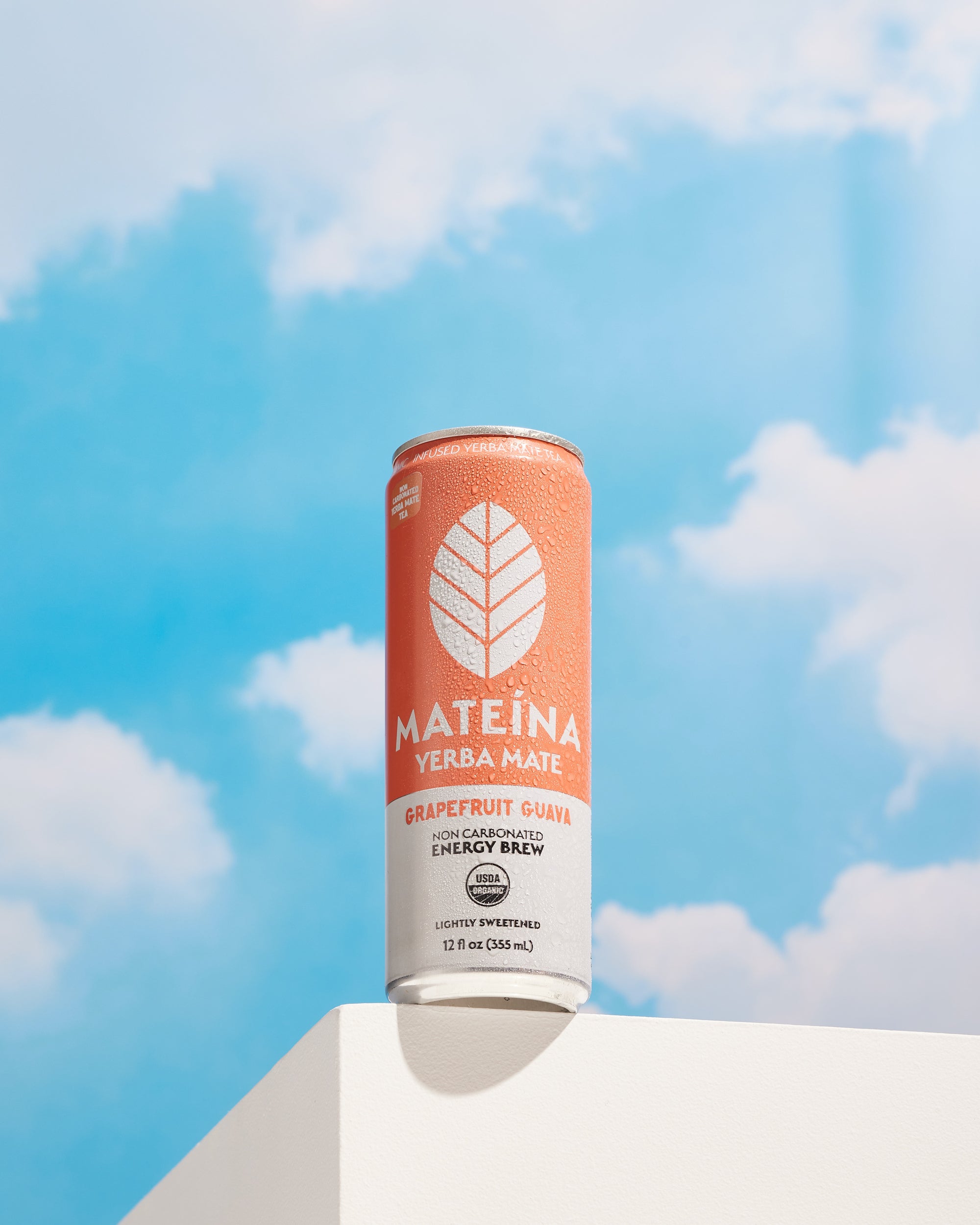 Mateina Yerba Mate Energy Brew - Grapefruit Guava can against a bright blue sky, showcasing its vibrant summer flavor.